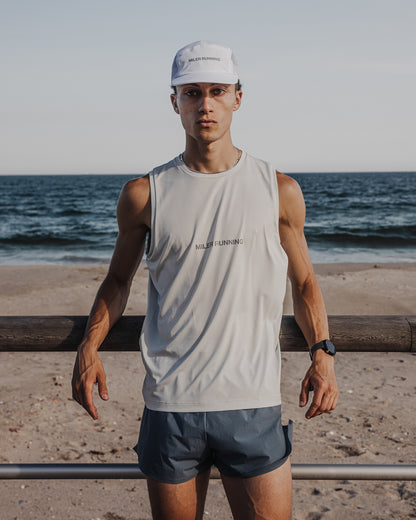 Runner on the beach wearing the white Base Running Hat